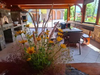 a vase filled with yellow flowers in a room at Apartments Štrancar wines in Ajdovščina