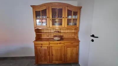 a wooden cabinet in the corner of a room at Hiša nad vinogradom in Ptuj