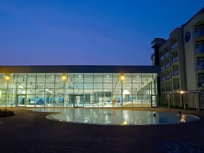 a large building with a large circle in front of it at Hotel Čatež - Terme Čatež in Čatež ob Savi