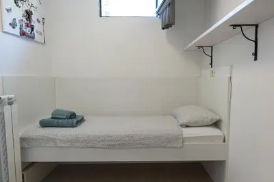 a bed in a small room with a window at Studio M&M in Nova Gorica
