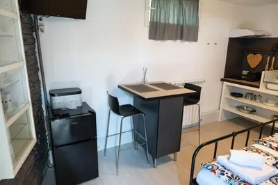 a black desk in a room with a bed at Studio M&M in Nova Gorica