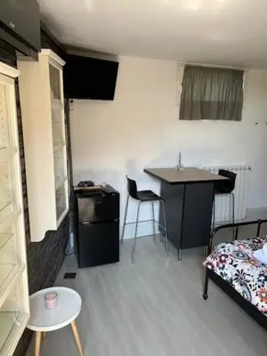 a room with a bed and a table and a desk at Studio M&M in Nova Gorica