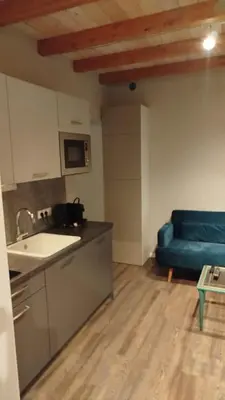a kitchen with a blue couch in a room at DEKO-LIME apartments in Ljubljana