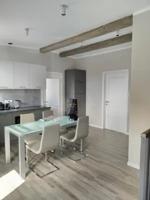 a kitchen with a table and chairs in a room at DEKO-LIME apartments in Ljubljana