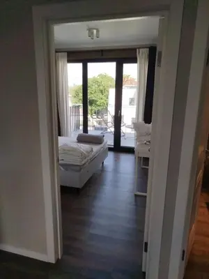 a living room with a bed and a sliding glass door at DEKO-LIME apartments in Ljubljana