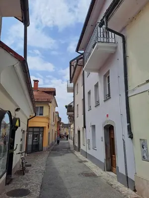 an alley with buildings and a person walking down the street at B&B Apartment for2 in Kranj