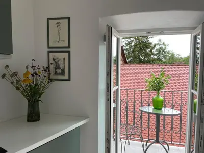 a room with a balcony with a table and a window at B&B Apartment for2 in Kranj