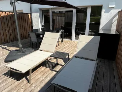 a patio with a table and chairs and an umbrella at Apartma 17 - Perla in Bovec