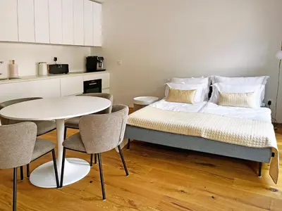 a bed in a room with a table and chairs at Apartma 17 - Perla in Bovec