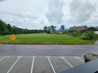 an empty parking lot with a field of grass at Grmač Apartments in Naklo