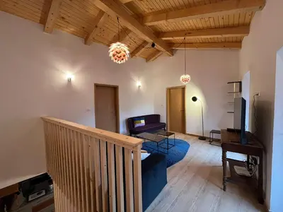 a living room with a couch and a tv at Hiša Blašč Wellness in Kobarid