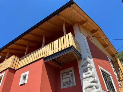a building with a balcony on top of it at Hiša Blašč Wellness in Kobarid