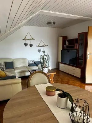 a living room with a couch and a table at green breeze - private jacuzzi retreat in Žalec