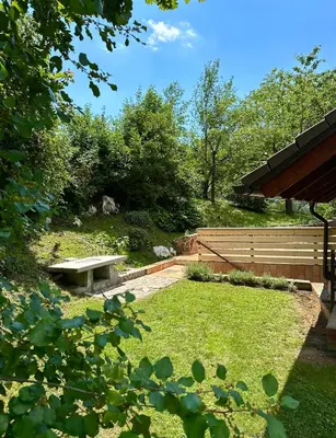a park with a bench in the grass at green breeze - private jacuzzi retreat in Žalec