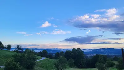 a view of a road on a hill with trees at Glamping Na Vrhu in Višnja Gora
