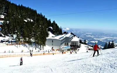a group of people skiing down a snow covered slope at ZenHouseApartment in Ljubno