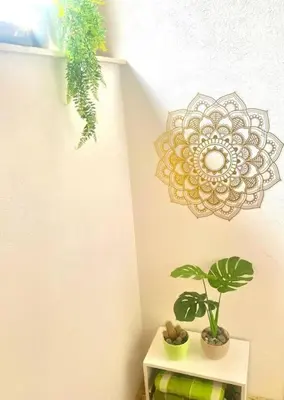a table with a plant and a clock on a wall at ZenHouseApartment in Ljubno