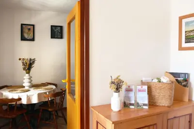 a dining room with a table and a table and a dining room at Apartmaji Žnidarčič in Divača