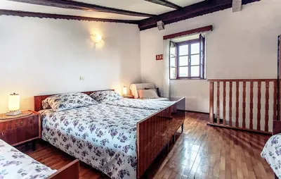 a bedroom with a large bed and a window at Apartmaji Žnidarčič in Divača