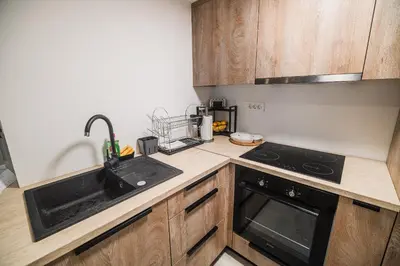 a kitchen with a sink and a stove at Apartment Trta with Vineyard View in Bistrica ob Sotli