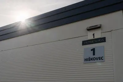 a white garage door with a sign on it at Hiškovec - Holiday Village in Trebnje