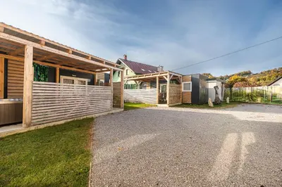 a house with a fence in front of it at Hiškovec - Holiday Village in Trebnje