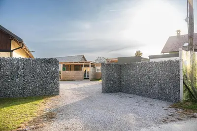 a stone fence in front of a house at Hiškovec - Holiday Village in Trebnje