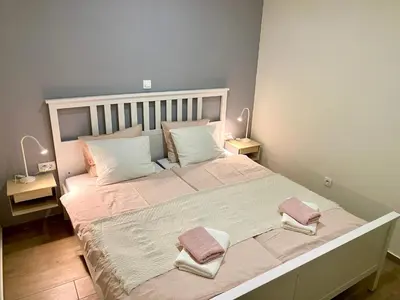 a bedroom with a large bed with two towels on it at Apartma Lastovka in Bled