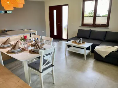 a living room with a table and a couch at Apartma Lastovka in Bled