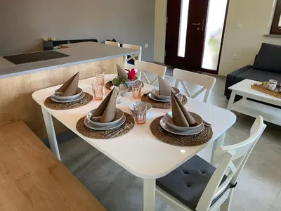 a white table with plates and bowls on top of it at Apartma Lastovka in Bled