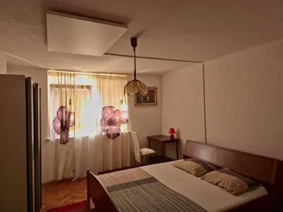 a bedroom with a bed and a room with a window at Apartment ML FREE PARKING in Loče pri Poljčanah