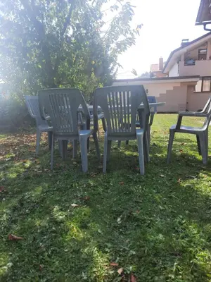a group of three chairs sitting in the grass at Apartment ML FREE PARKING in Loče pri Poljčanah