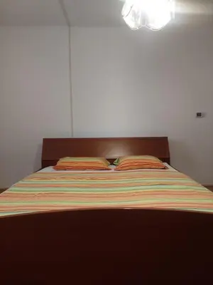 a bed with two pillows on it in a bedroom at Apartment ML FREE PARKING in Loče pri Poljčanah
