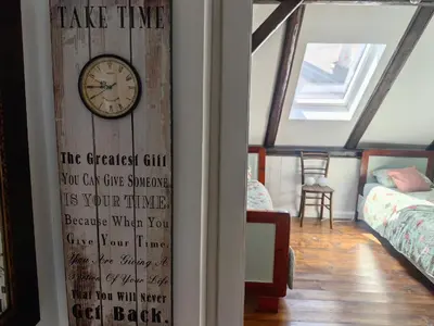 a clock on a wall in a room at Hiša Hortenzija Luče in Luče