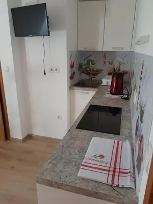 a kitchen with white cabinets and a counter top at Encijan in Bohinj