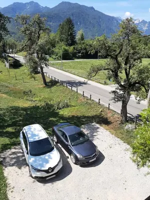 two cars parked on the side of a road at Encijan in Bohinj