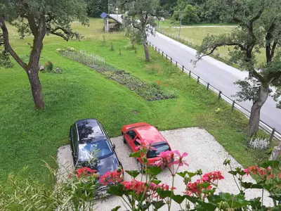 a red car parked on the side of a road at Encijan in Bohinj
