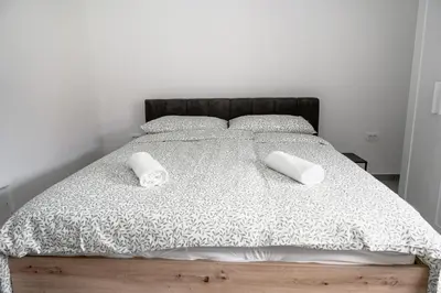 a bedroom with a bed with two towels on it at Hiša Krn in Kobarid
