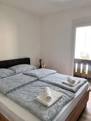 a bedroom with a bed with towels on it at Hiša Krn in Kobarid