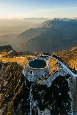 an aerial view of a crater in the middle of a mountain at Apartma v objemu gora - Krvavec in Cerklje na Gorenjskem