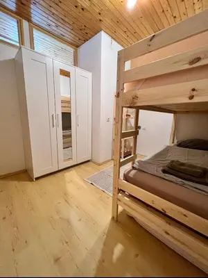 a bedroom with a bunk bed and white cabinets at Apartma v objemu gora - Krvavec in Cerklje na Gorenjskem