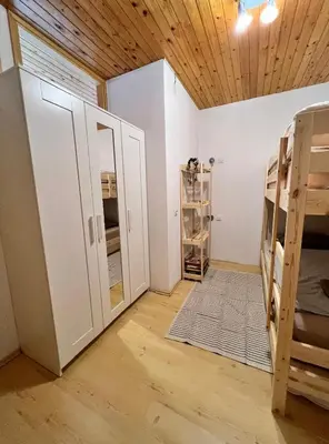a room with two bunk beds and a mirror at Apartma v objemu gora - Krvavec in Cerklje na Gorenjskem