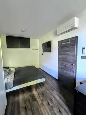 a room with a bed and a closet and a door at Central Ljubljana Apartment in Ljubljana