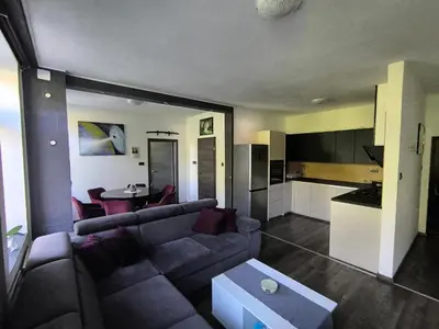 a living room with a couch and a table at Central Ljubljana Apartment in Ljubljana