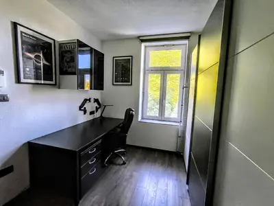 a home office with a desk and a window at Central Ljubljana Apartment in Ljubljana