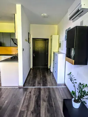 an empty room with a kitchen and a hallway at Central Ljubljana Apartment in Ljubljana
