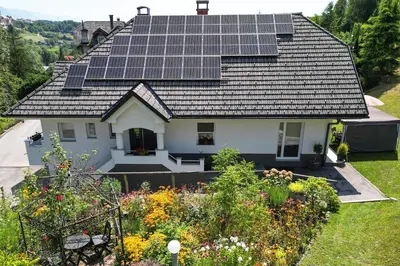 a house with solar panels on the roof at Apartma Matevž in Radovljica
