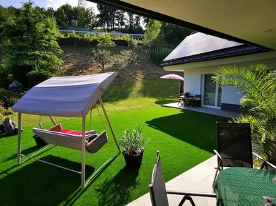 a patio with a chair and an umbrella at Apartma Matevž in Radovljica