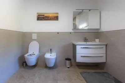 a bathroom with a toilet and a sink at Apartma Matevž in Radovljica