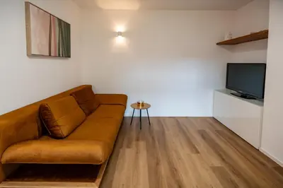 a living room with a couch and a tv at Hidden Corner in Žirovnica